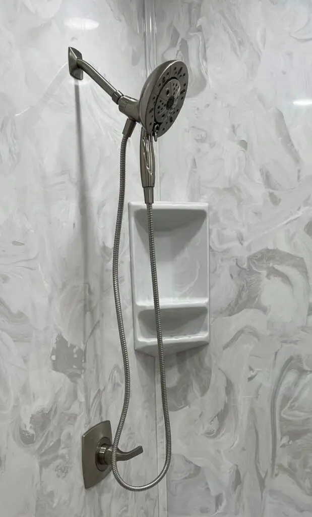 Brushed nickel shower valve trim and handle installed by TennCo. Plumbing